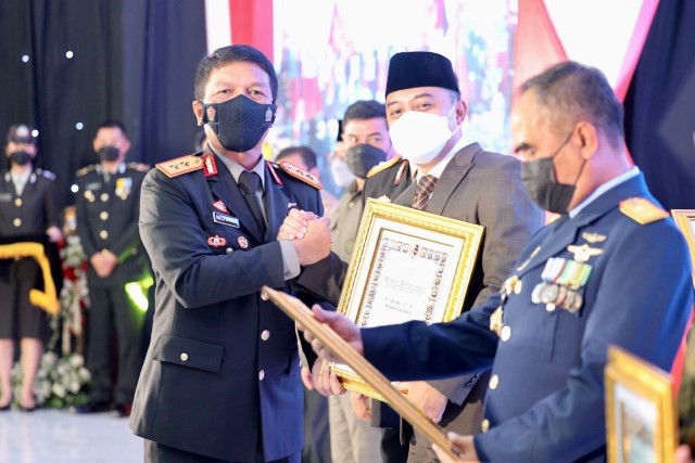 Kapolda Jawa Timur Irjen Pol Nico Afinta saat menyerahkan penghargaan Tan Hana Dharma Mangrva kepada Wali kota Surabaya Eri Cahyadi di upacara peringatan hari Bhayangkara ke 76 di Mapolda Jatim